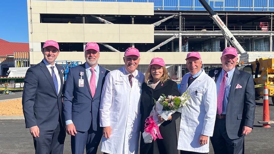 Members of Renown Health team stand in front of specialty care center construction 