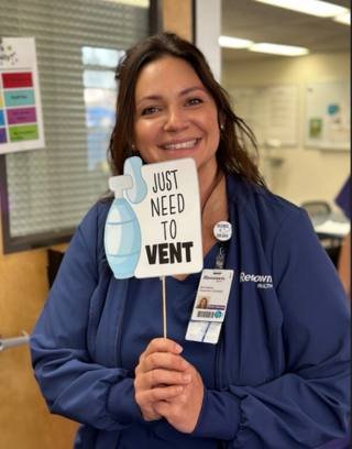 Erin Hanna posing with "Need to Vent" Sign