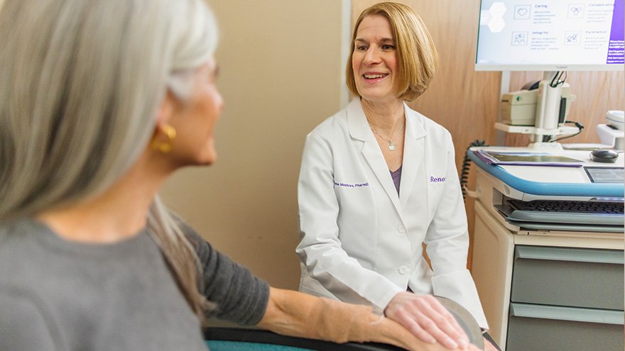 Pharmacist Dyane Meadows reviewing information with a patient