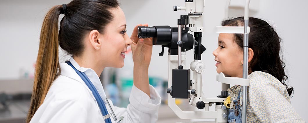 Ophthalmologist with pediatric patient