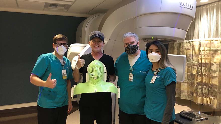 Renown patient Michael Millman stands with employees