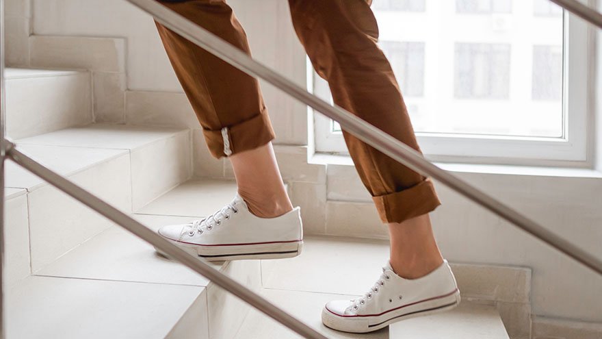 Woman's feet walking up stairs