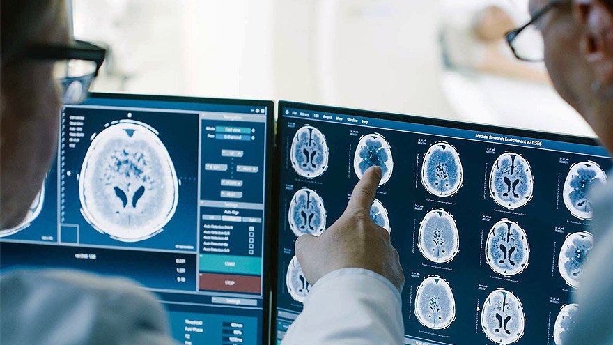 Doctors looking a computer screen