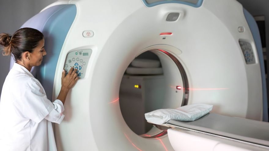 Clinical employee using MRI machine
