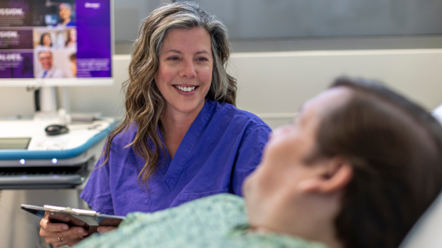 A provider at Renown Health speaks with a bariatric patient in an exam room.