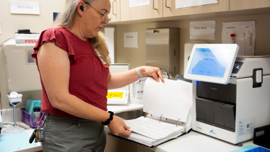 Wende with Point of Care reviews records and equipment.
