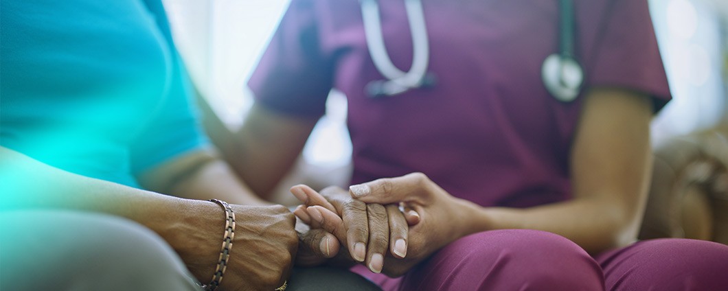 Nurse holding patient's hand