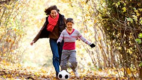 Mother and daughter playing with a soccer ball