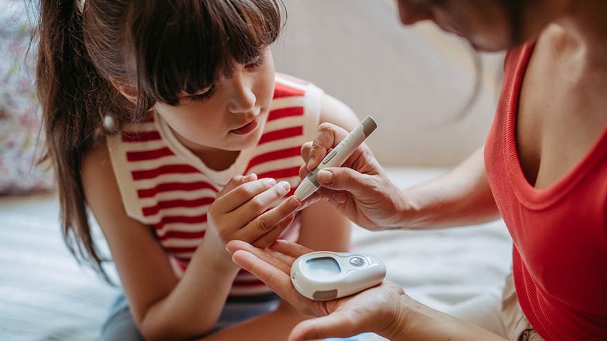 Mother taking her daughter's blood sugar