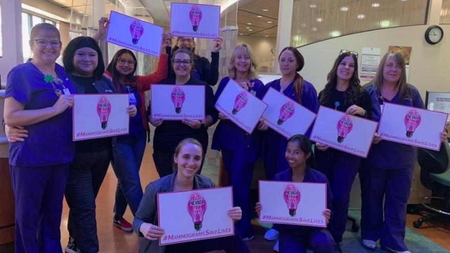 The Infusion Services team poses with Paint Nevada Pink signs for Breast Cancer Awareness Month.