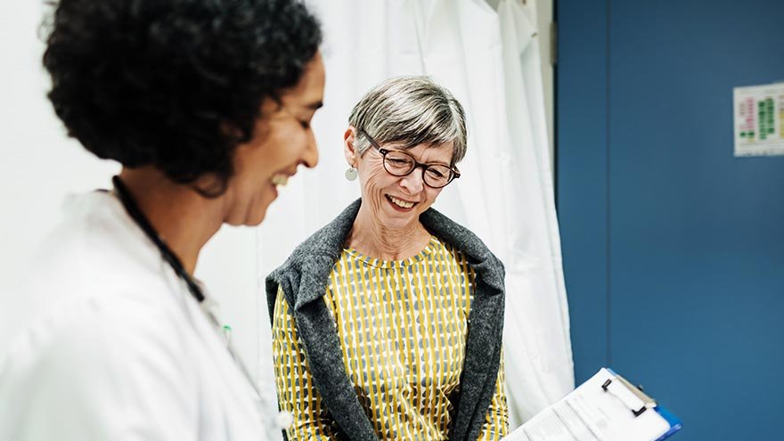 Medical professional going over test results with female patient