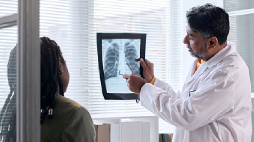 Provider reviewing x-ray with patient