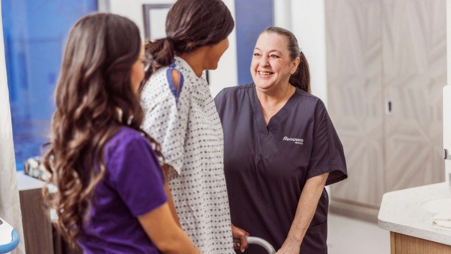 Certified Nursing Assistant Helping Patient