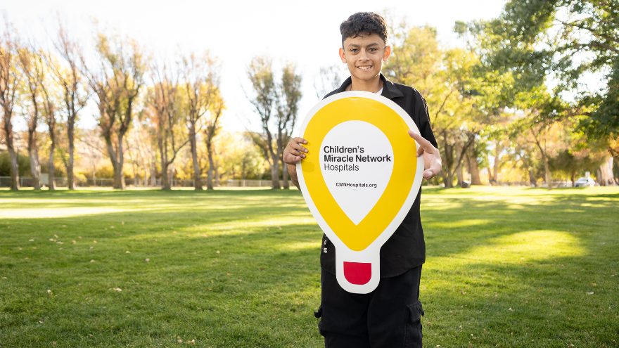 Gio Melgarejo, the 2025 Children's Miracle Network Champion Child for Renown Children's Hospital, poses for a photo with the Children's Miracle Network Hospitals balloon sign.