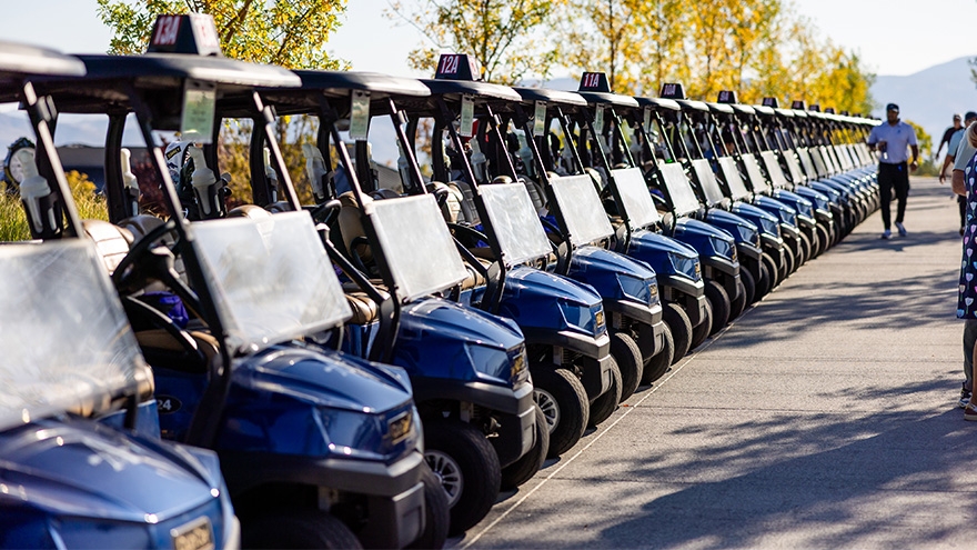 Row of golf carts parked at ArrowCreek Golf course.