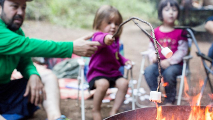 Dad making smores at the campire with girls