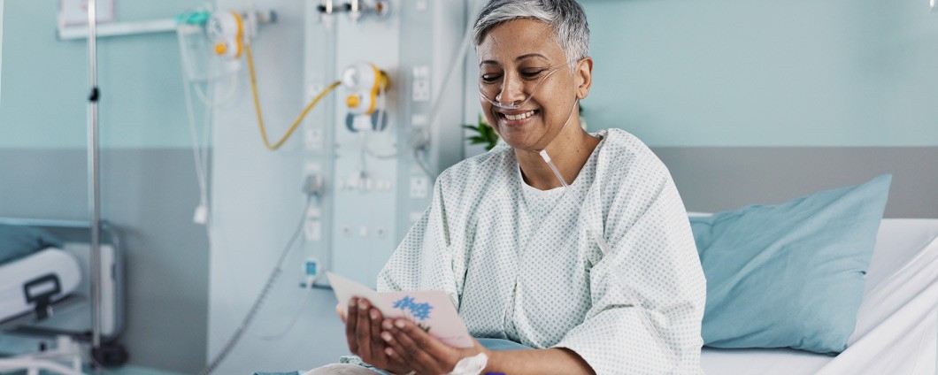 Happy woman in hospital reading personal note