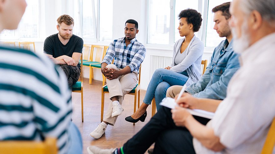 Adults participating in a group therapy session