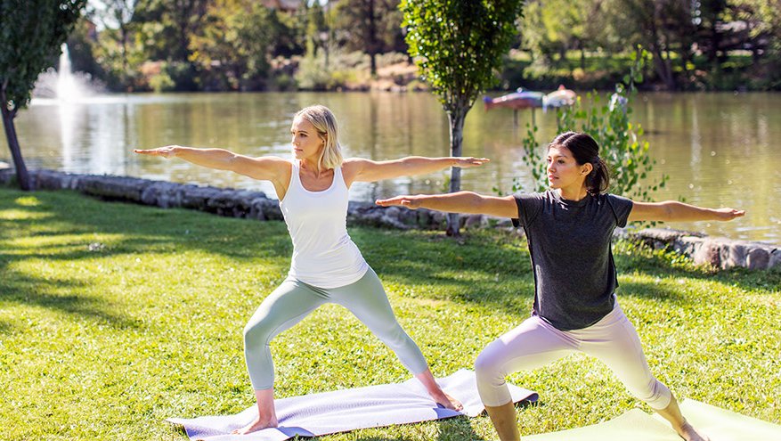 Two women doing yoga at Idlewild Park