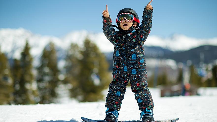 Kid snowboarding in a helmet