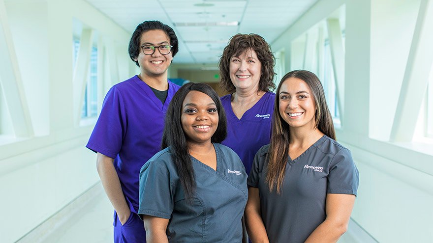 Four employees stand together.
