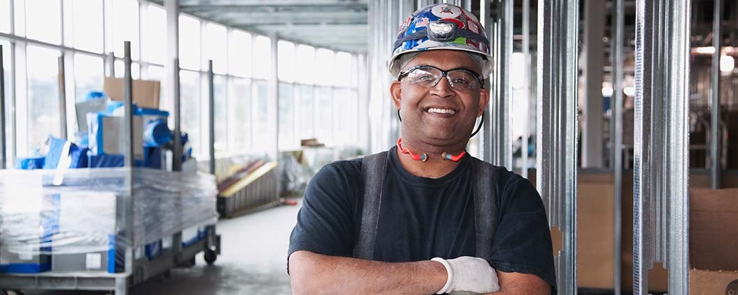 Male construction worker on hard hat smiling