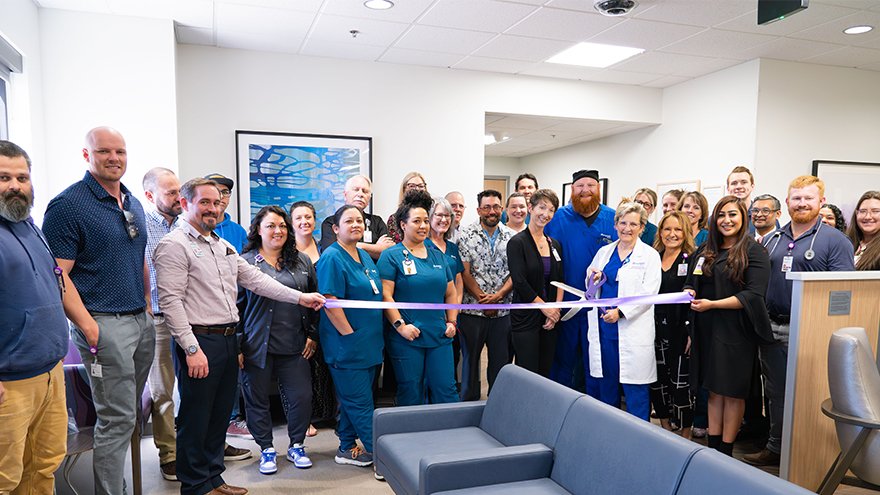 Team poses for ribbon cutting event