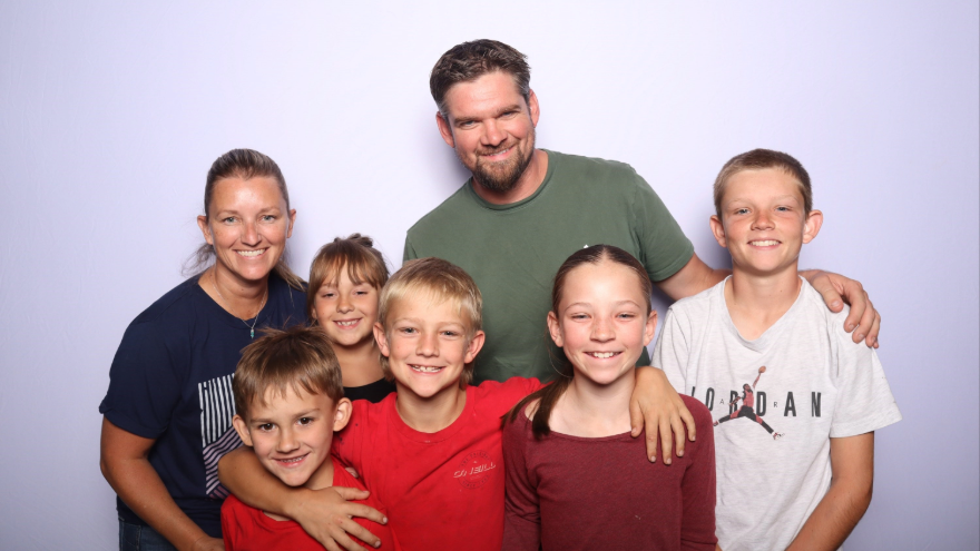 Photo of Family, showing Heather, her husband, and 5 children.