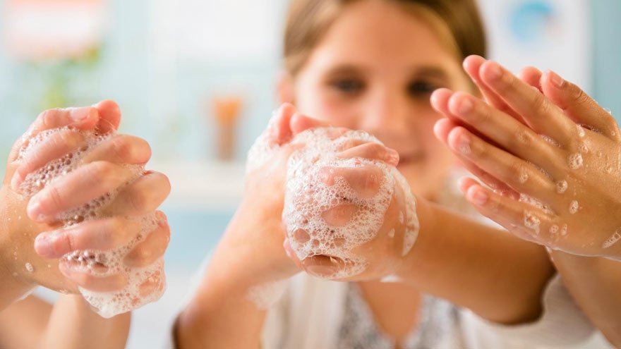 Child washing hands with soap