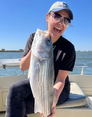Callee Amari posing with fish after fishing on a boat