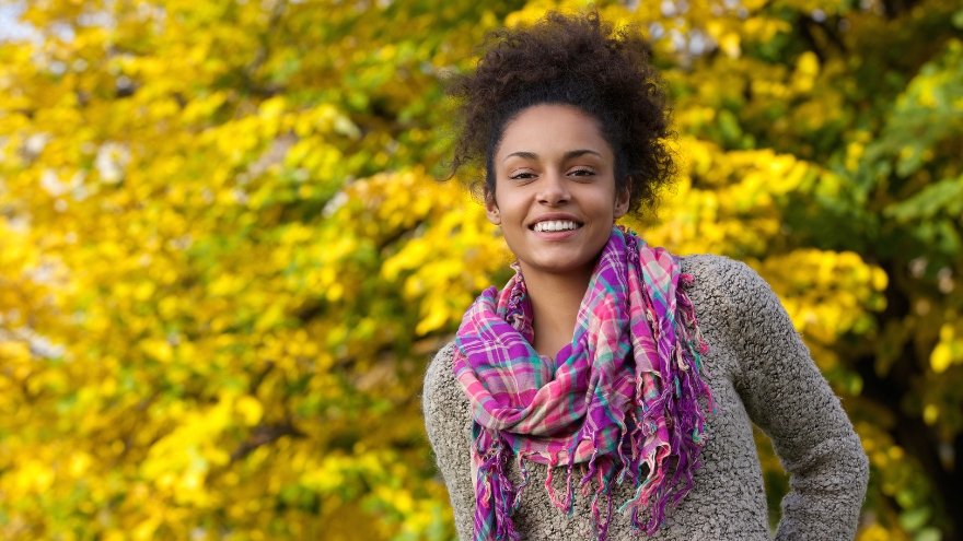 Woman enjoying the fall leaves