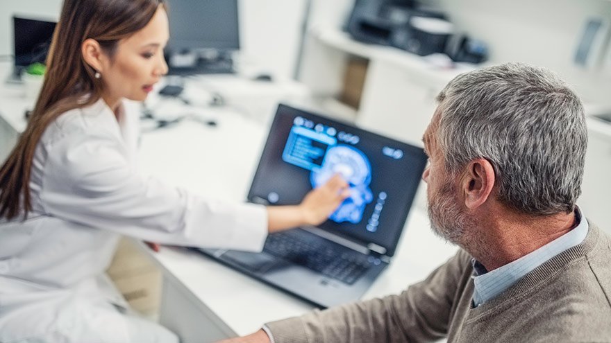 Female doctor showing brain scan to patient