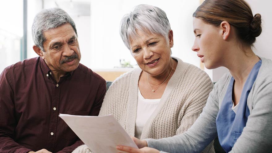 Elderly couple talk to healthcare provider