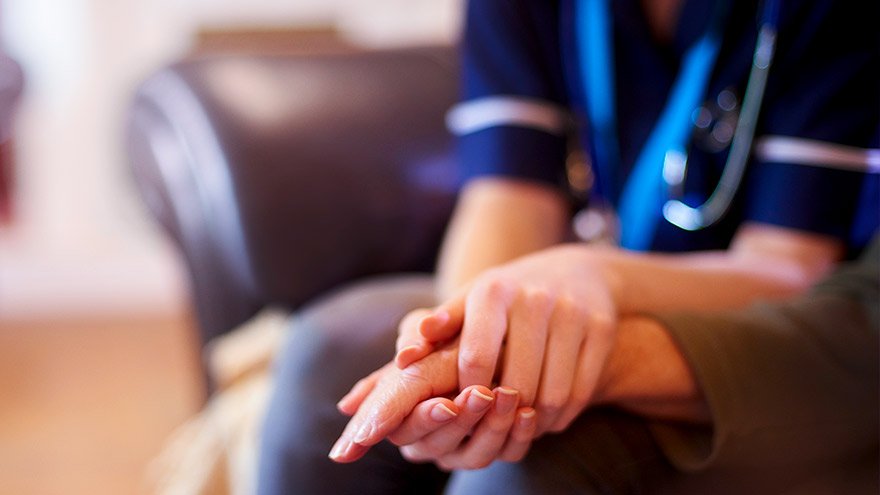 Provider holding patient's hand