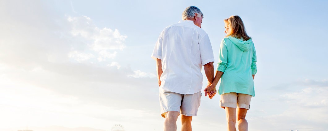 Mature couple walking on beach