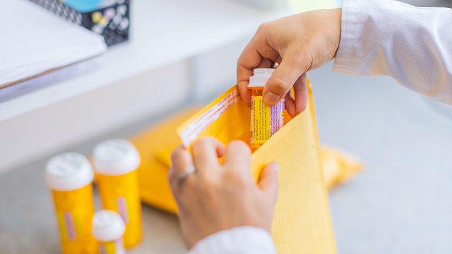 Renown Pharmacy employee filling mail prescription