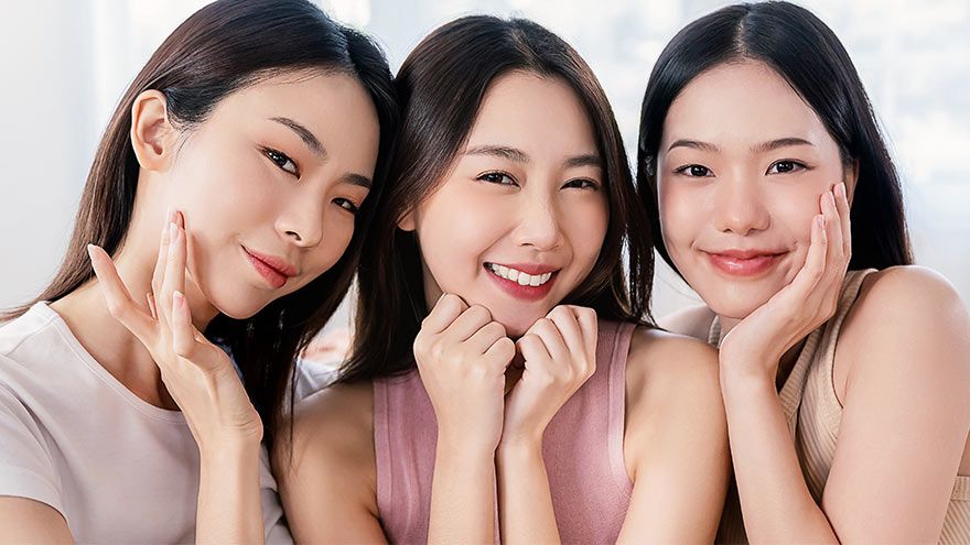 Three teens in a group smiling