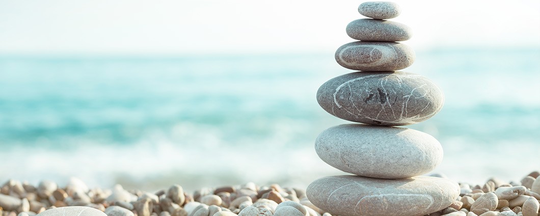 Zen rocks stacked on beach