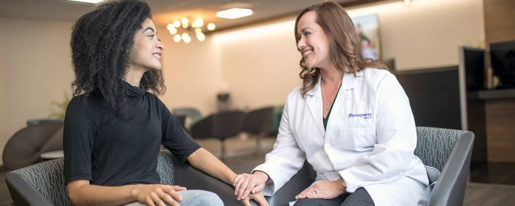 Renown provider speaking with patient in waiting area