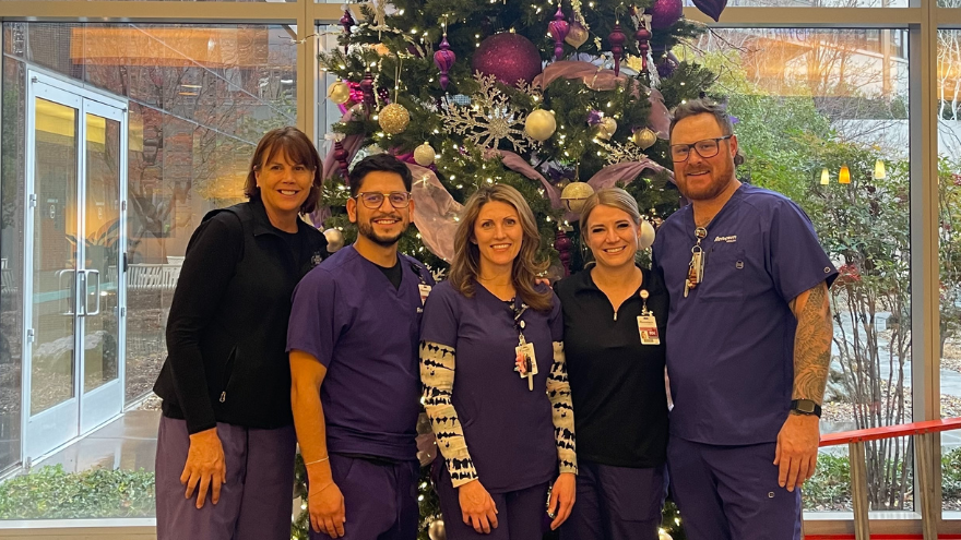 The Vascular Access team at Renown Regional Medical Center pose for a group photo in front of Renown's Christmas tree.