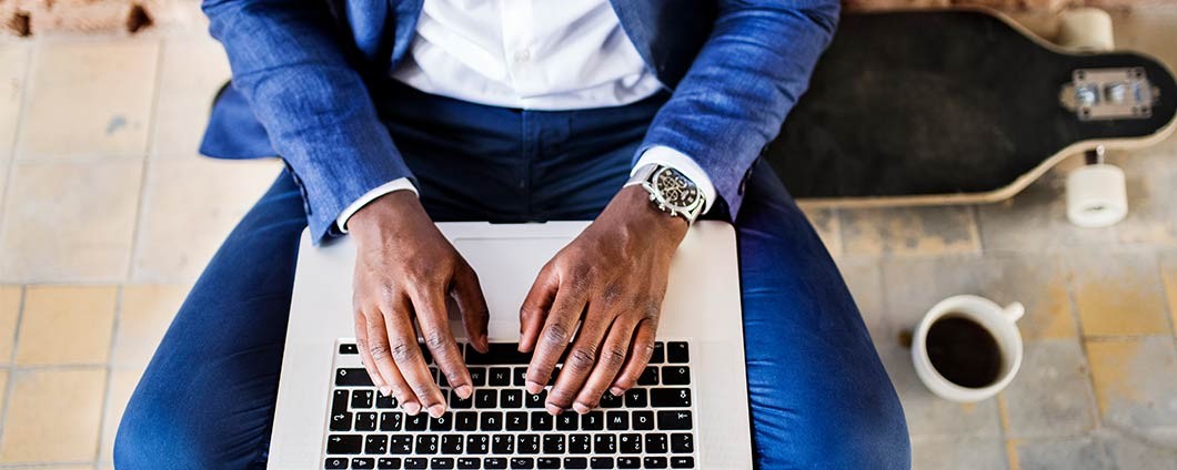 Man updating information on his laptop