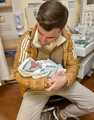 Dr. Cucalon Calderon holding newborn baby