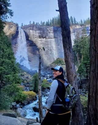 Amanda posing in front of waterfall