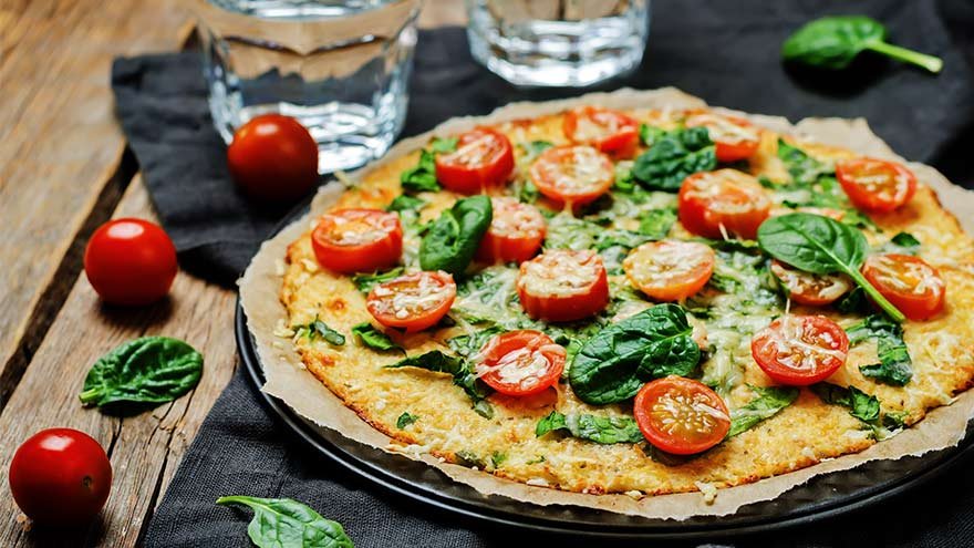 A dish with tomatoes on top