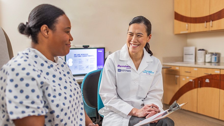 a doctor is talking to a patient in a hospital room .