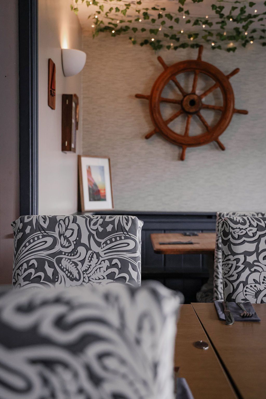 A cosy corner of the bar with the Ship Aground sign on the slate wall