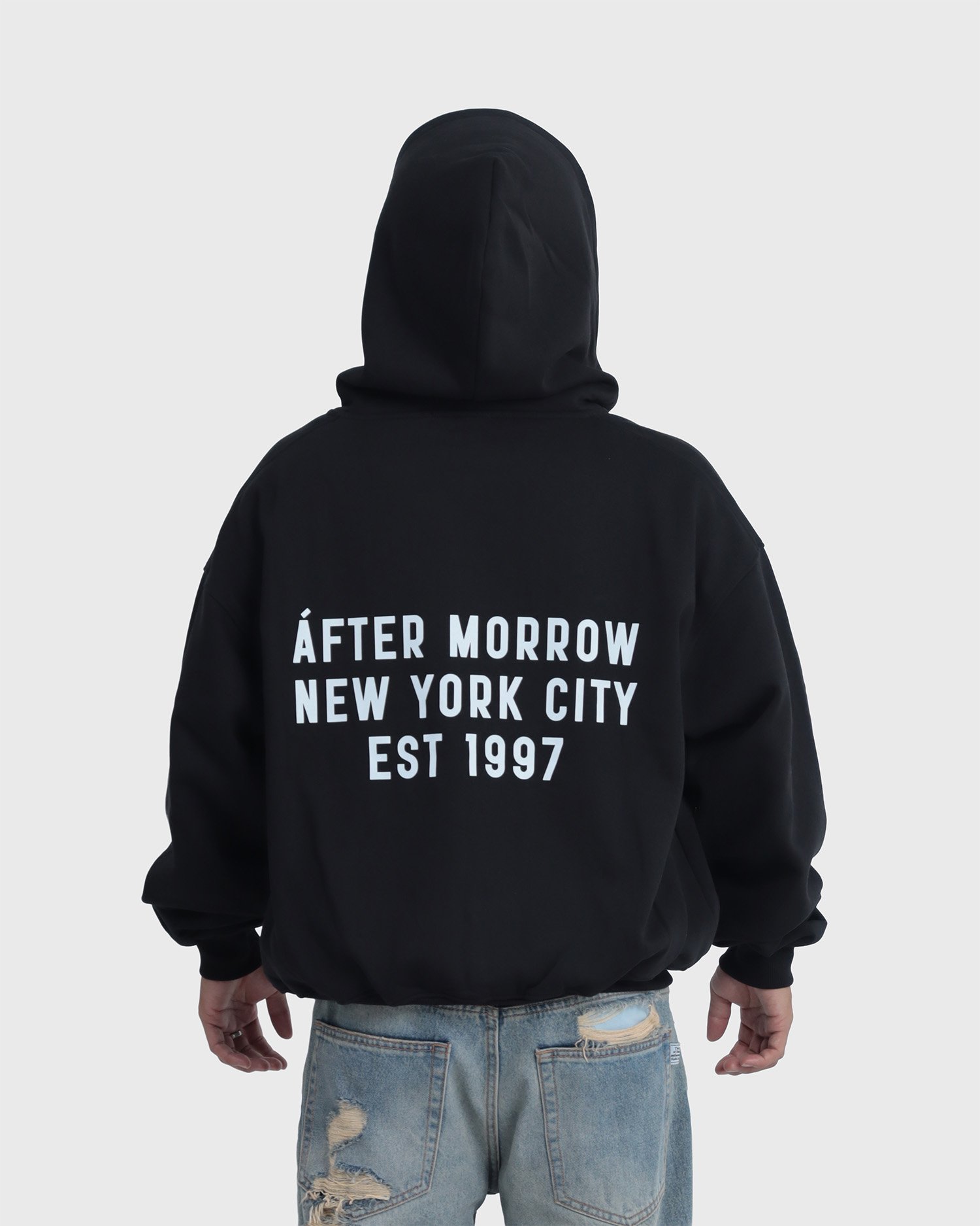 Model wearing the black AFTERMORROW heavyweight zip hoodie from the back