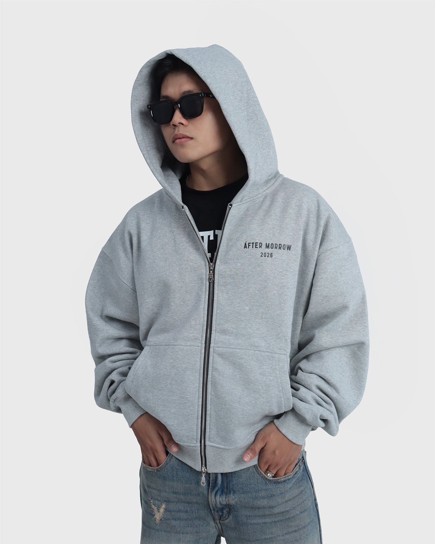 Model wearing the grey AFTERMORROW heavyweight zip hoodie from the front