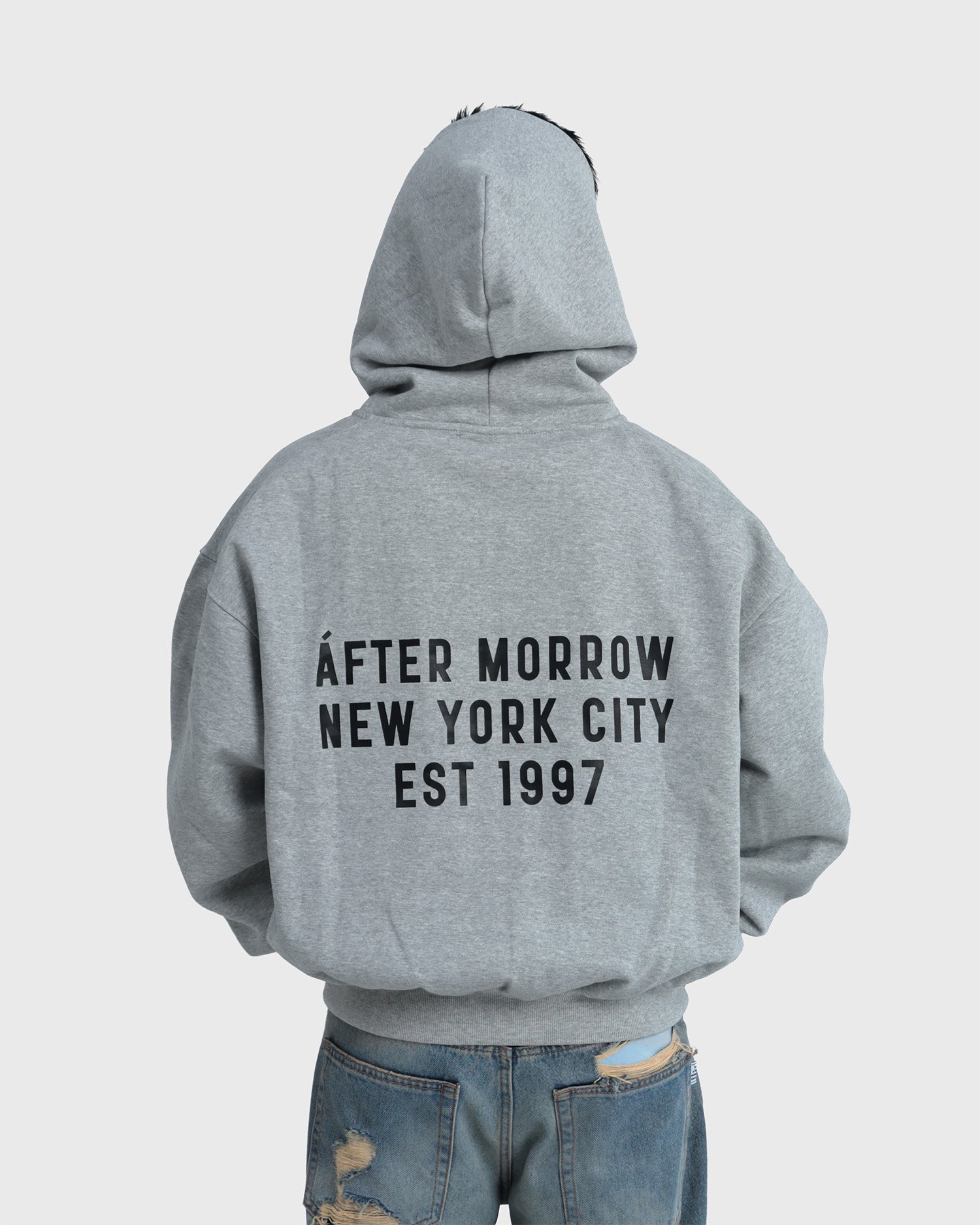 Model wearing the grey AFTERMORROW heavyweight zip hoodie from the back