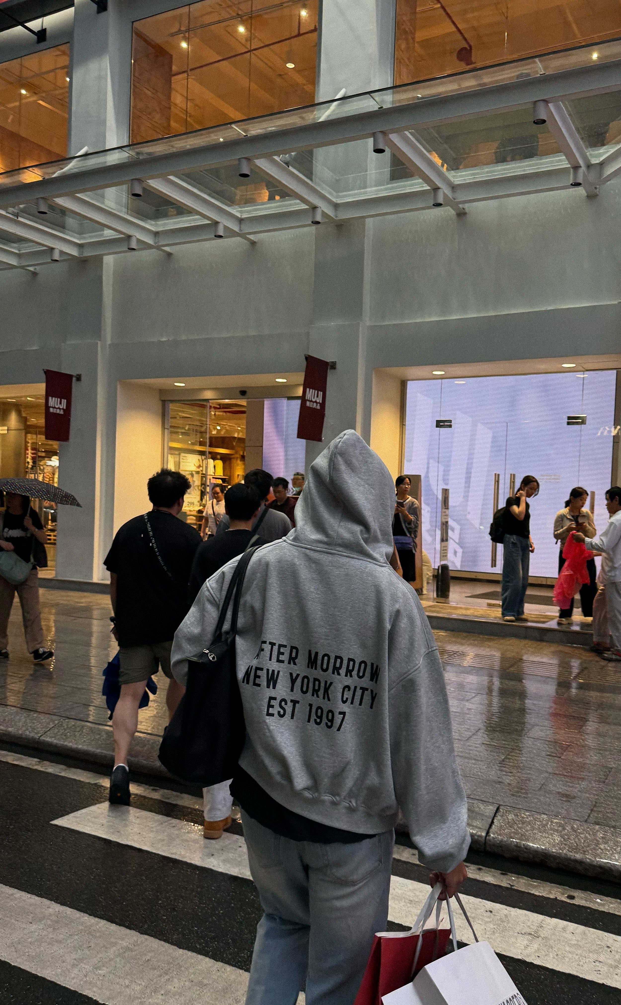 Grey AFTERMORROW Hoodie 1997 on a rainy city street